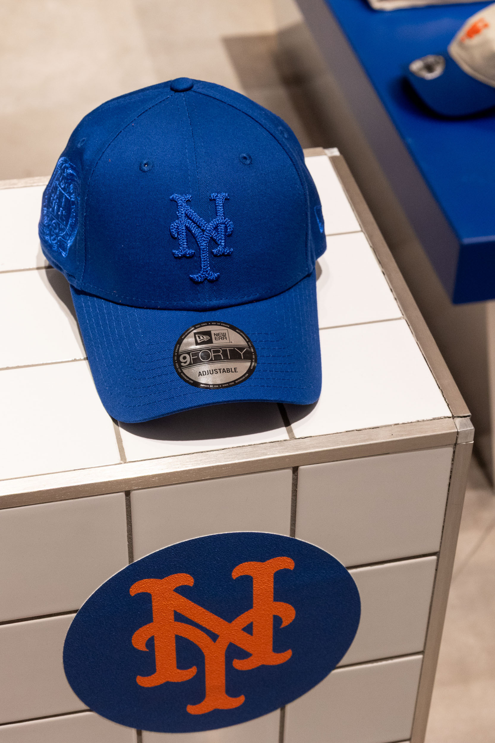 Branded cap display within a retail pop-up activation featuring product merchandising, sports-inspired storytelling and experiential retail design