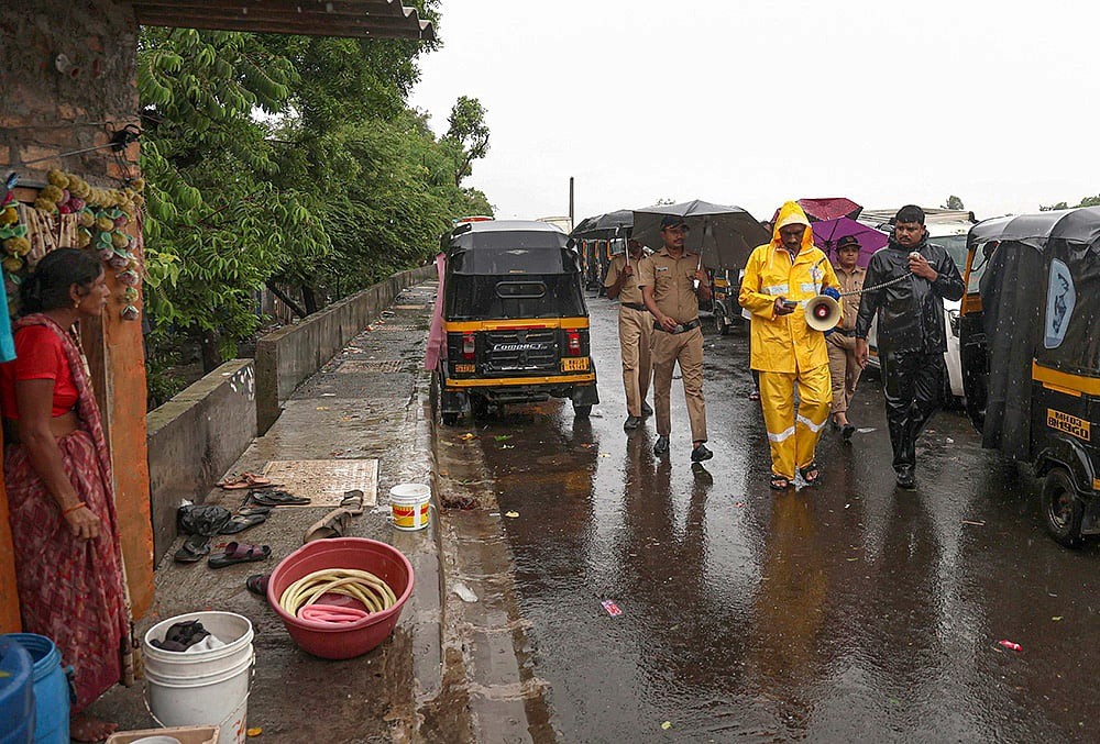Police and administration officials patrol as the Mithi river rises towards the danger mark, Mumbai, July 6, 2026.