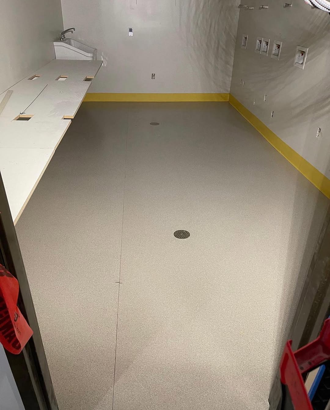 Completed sheet vinyl floor with welded base trim in a finished room