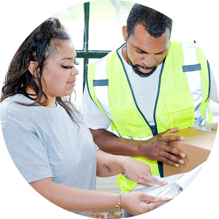 Two people checking a shipping manifest