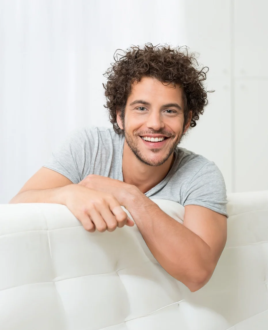 Young man smiling comfortably before wisdom teeth removal consultation at an oral surgery practice in Fresno, CA