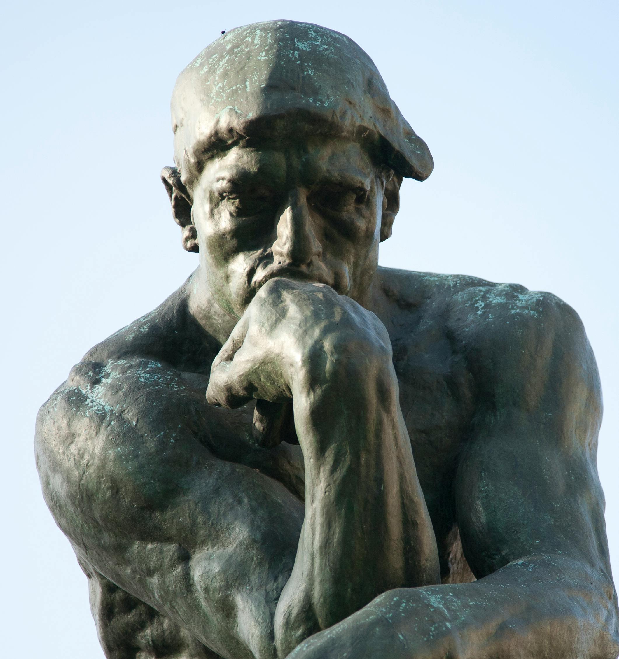A statue of "The Thinker" by Rodin, which depicts a man deep in thought. 