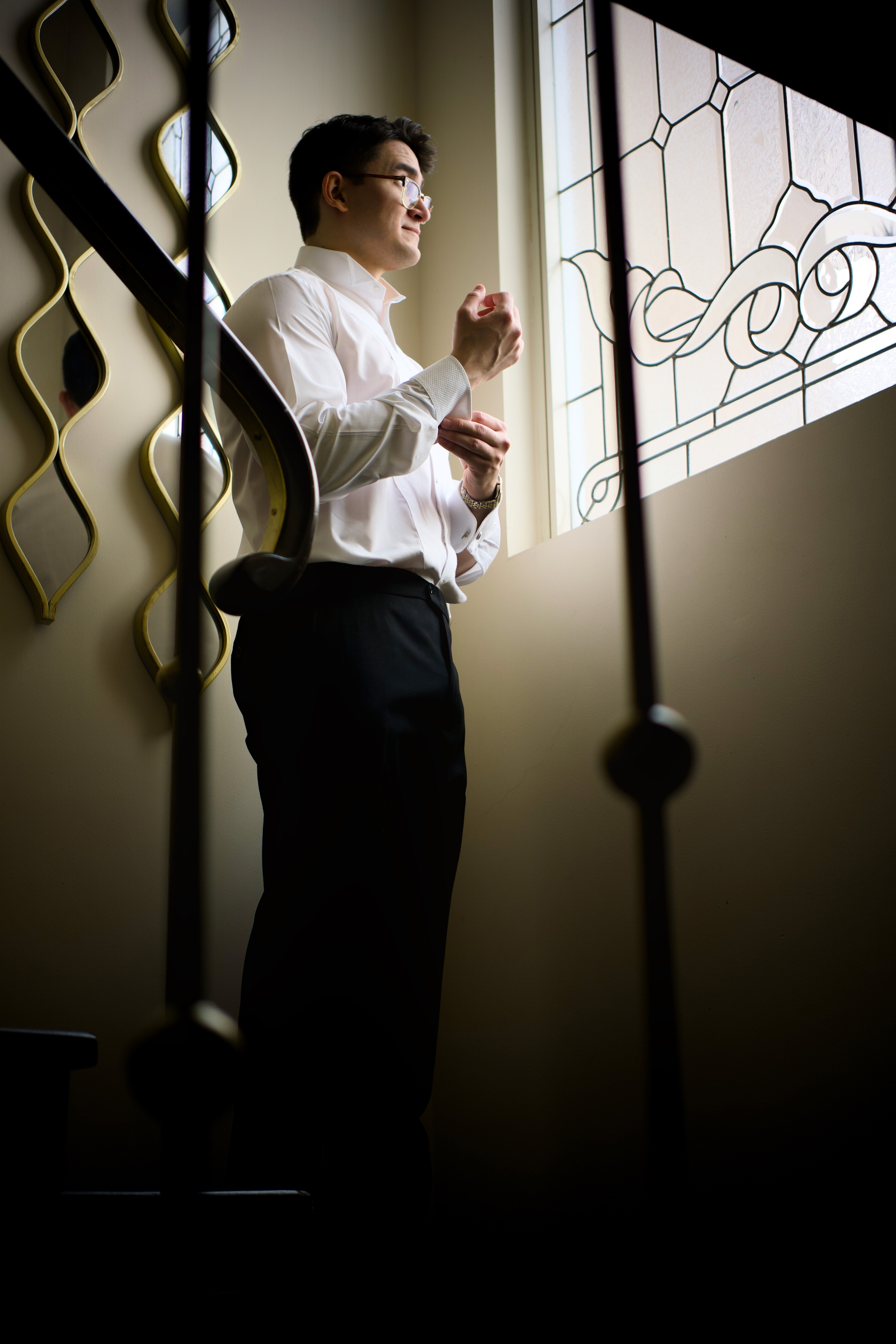Person stand in front of a red sports oldtimer