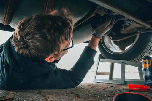 Man under a car, fixing it