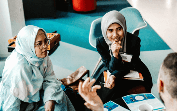 Two women listening intently in a conversation.