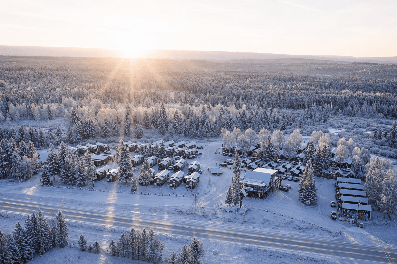 Blue Buffalo Resort Cabins from above, covered in snow, showing the entire resort.