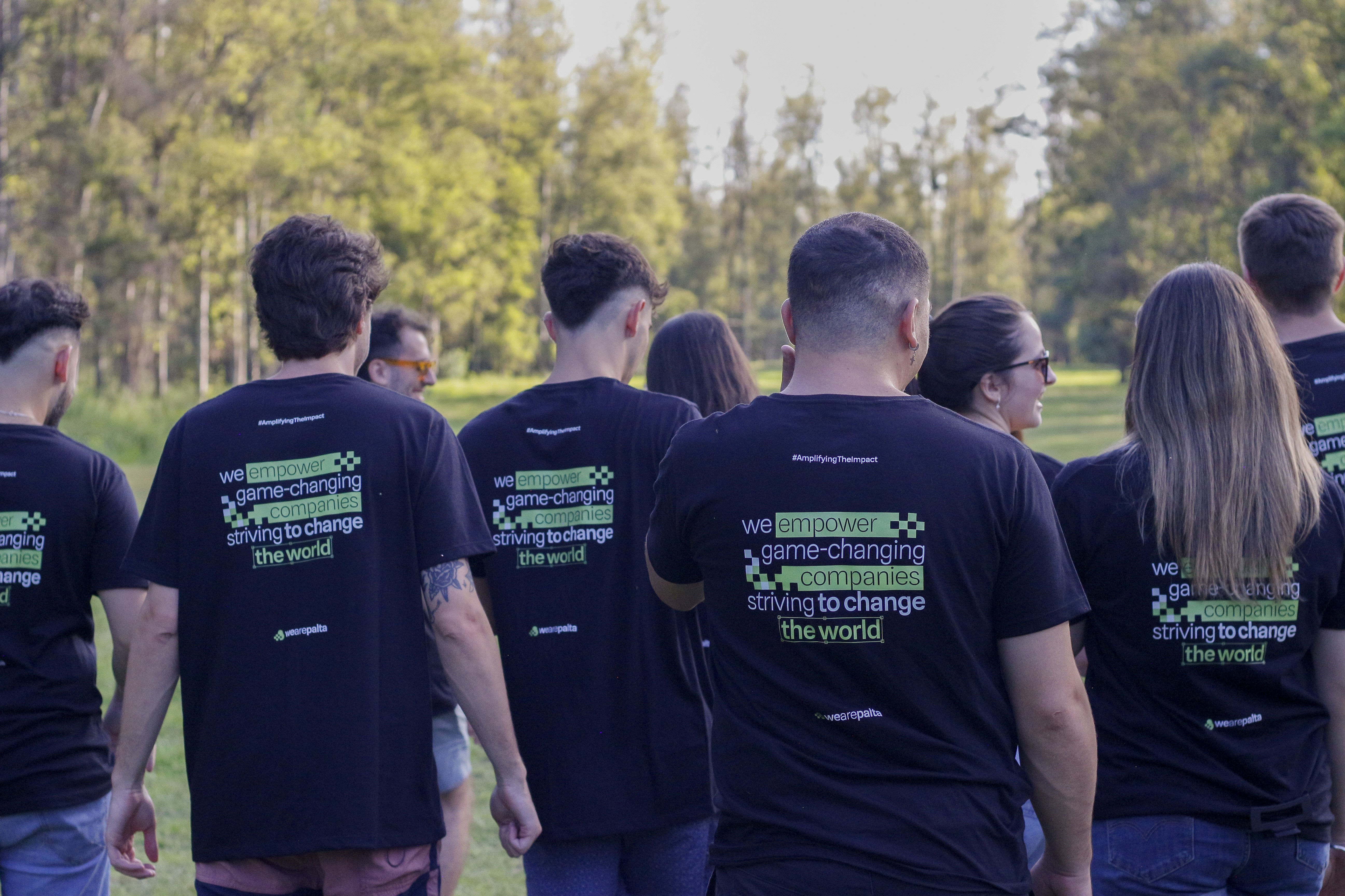 Team members of WeArePalta walking in a park.