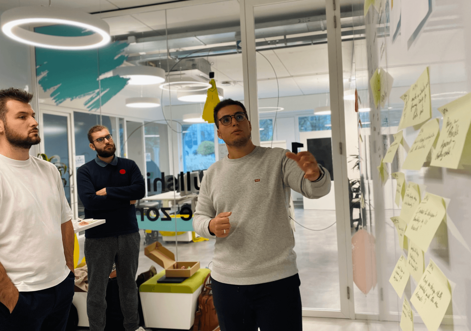 Problem-solving workshop with a team collaborating and using sticky notes to generate solutions in a modern office in Belgium