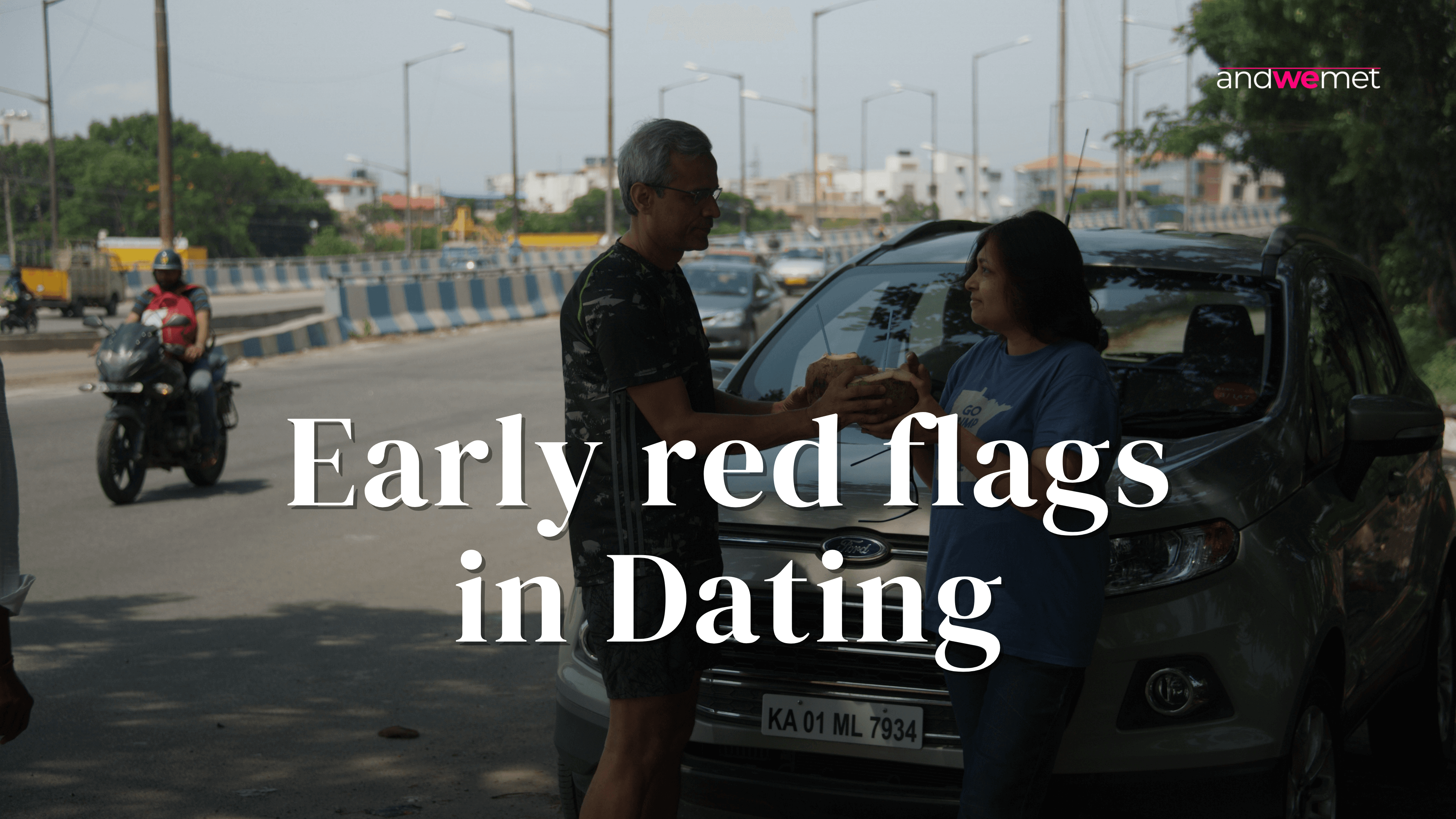 Couple having tense conversation by car on street representing early dating warning signs and red flags - andwemet relationship advice