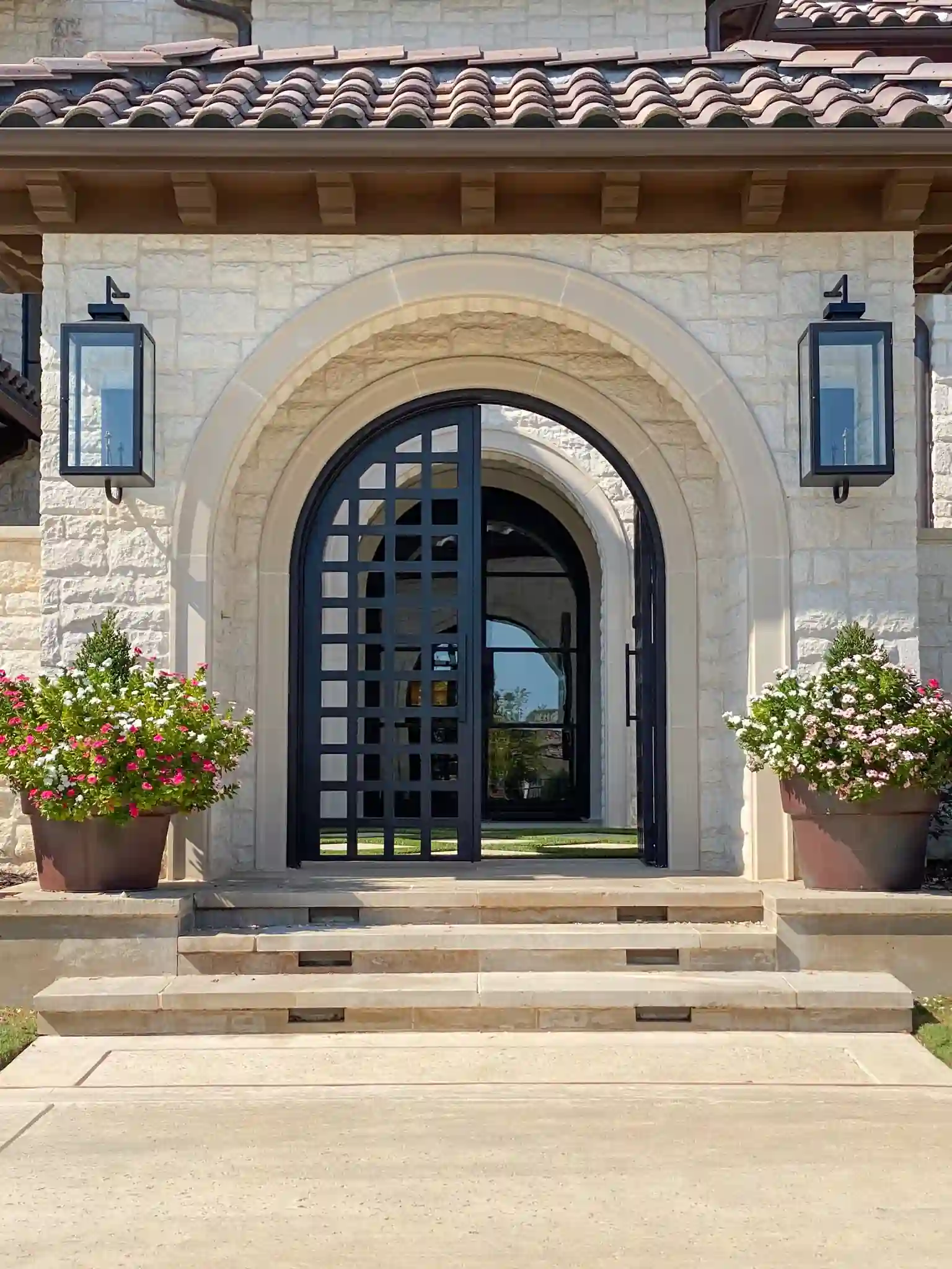 modern iron front gate entrance leading up to an entryway by M2 Metals Iron Doors DFW