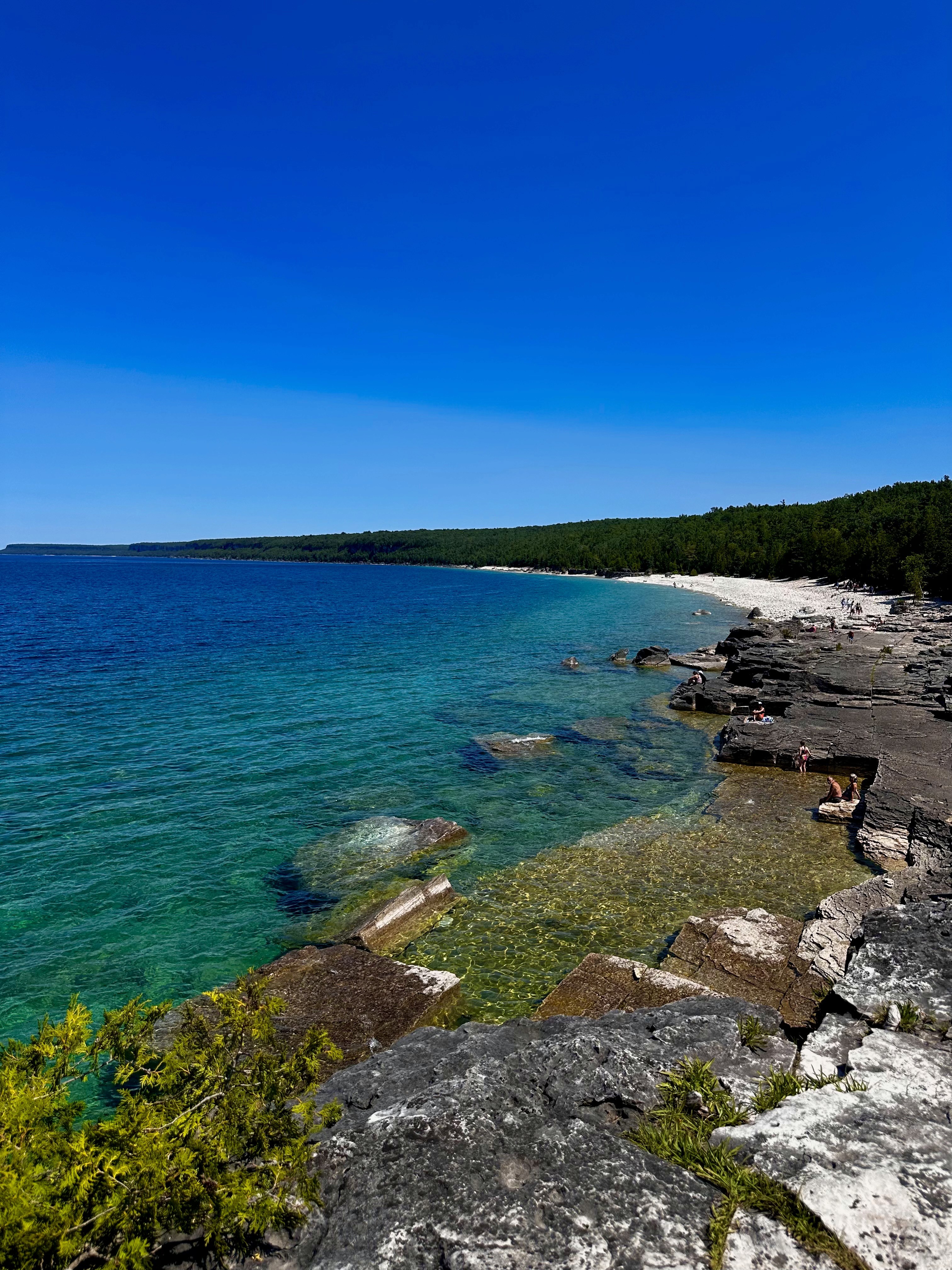 a group of people walking on a sidewalk