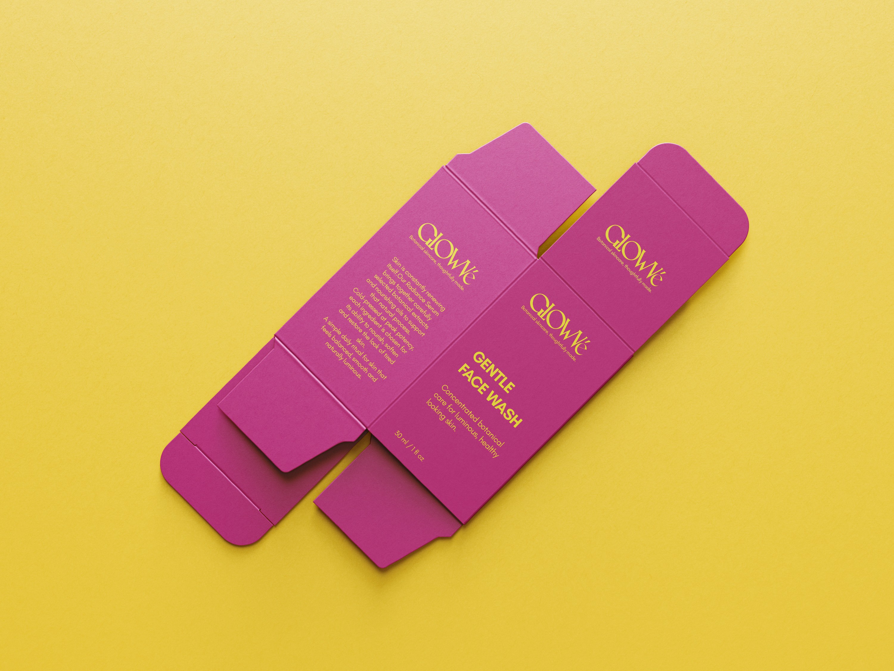 Stacked pink and red glass cosmetic jars on white—minimal skincare packaging display.