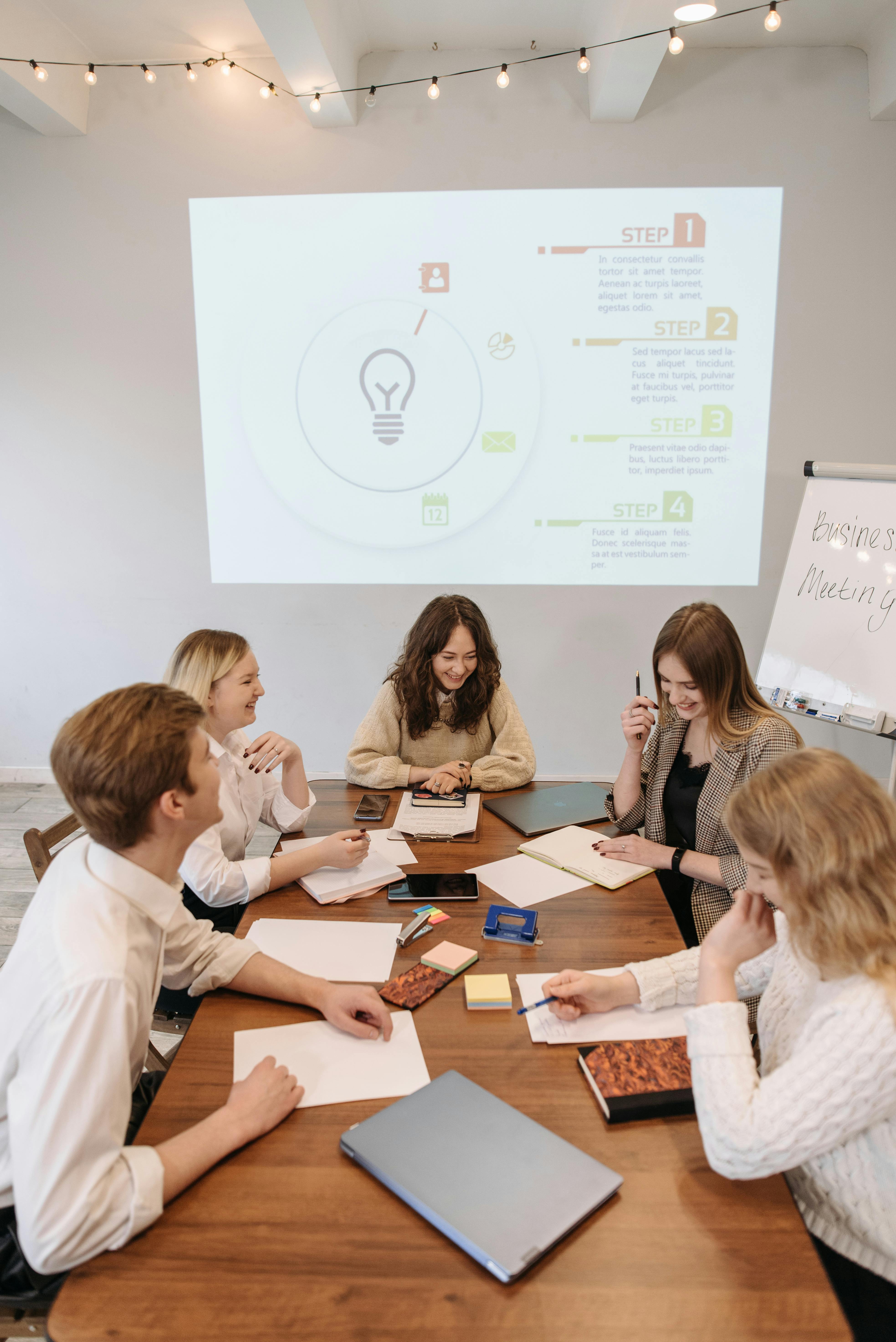 team-discussing-ideas-at-a-business-meeting-with-a-presentation-in-the-office. - pavel-danilyuk (pexels)