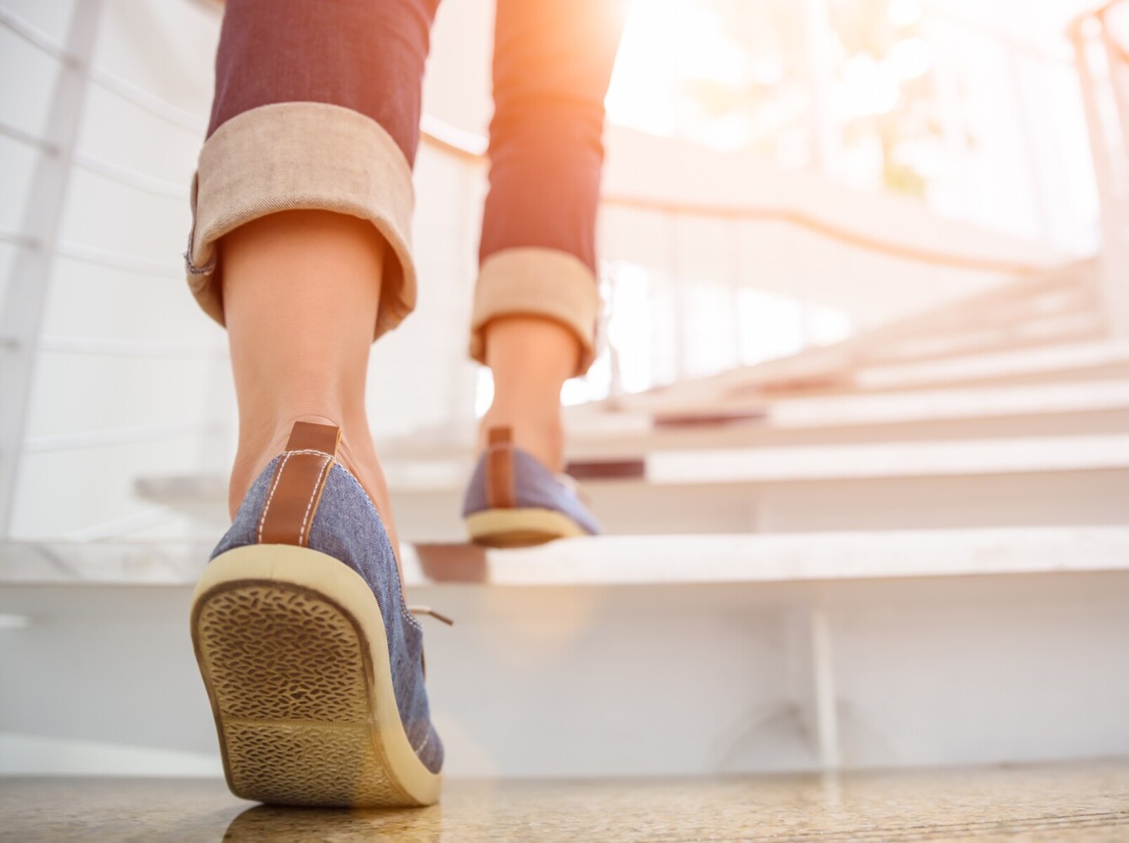 feet of a woman walking up the stairs to add to NEAT for how much walk to lose weight