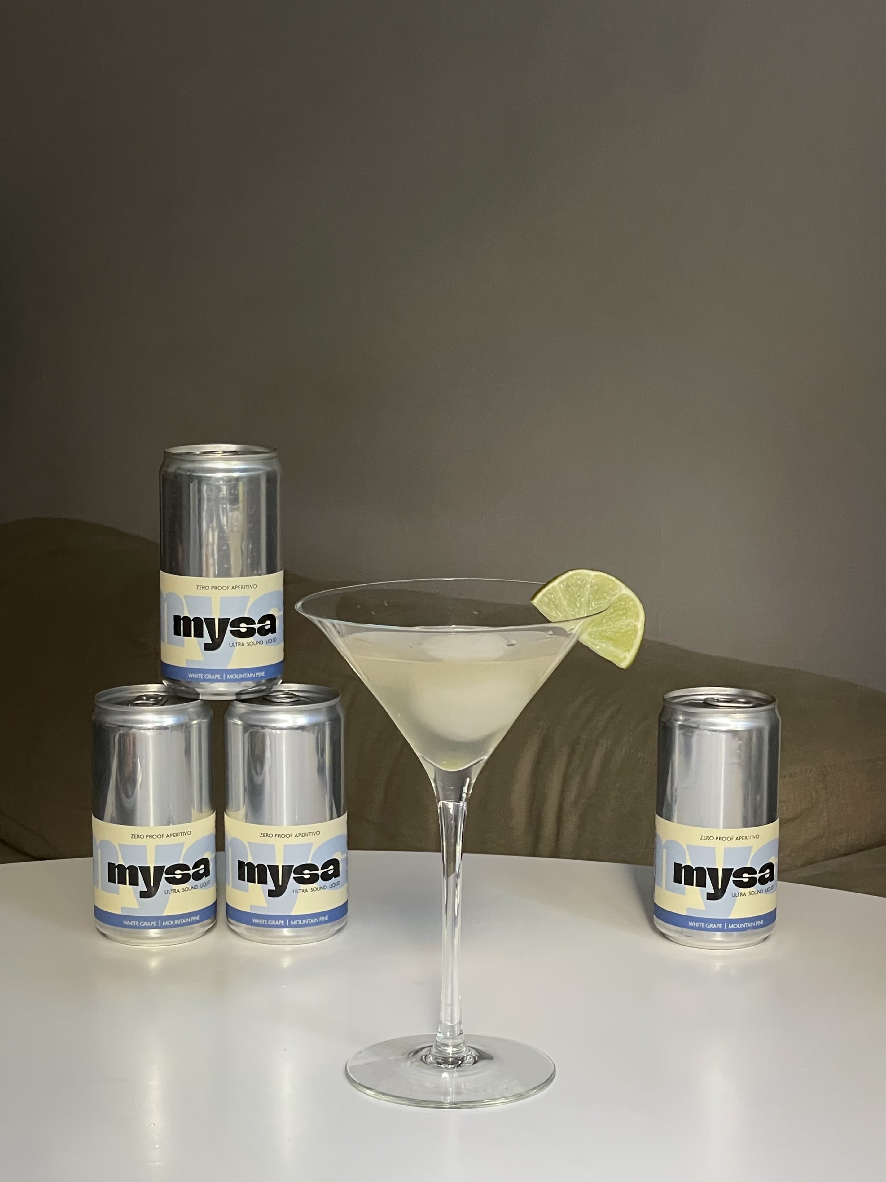 close-up of mysa served in a crystal coupe glass with a chili and square ice cube