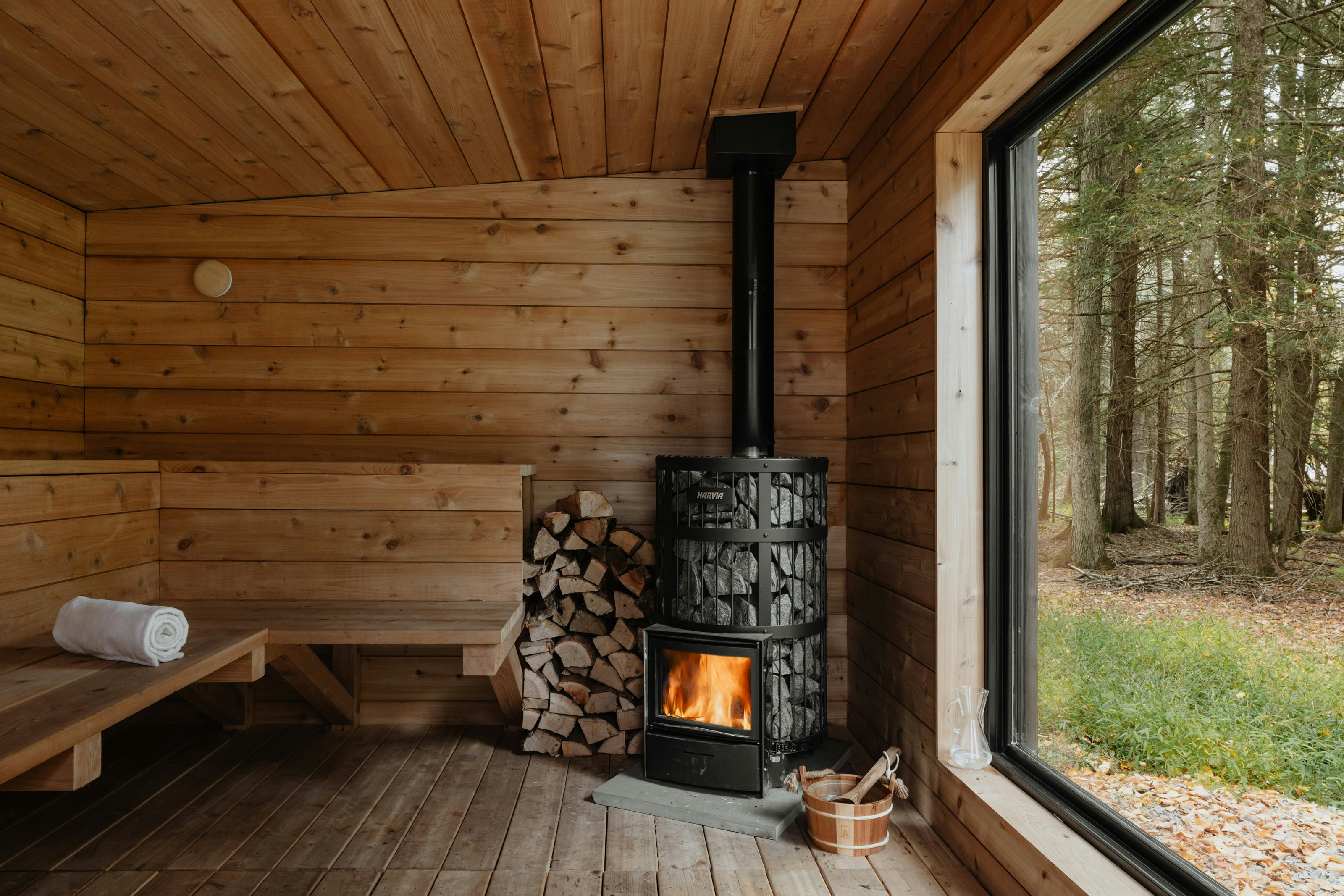 A wood burning stove inside of a wooden cabin