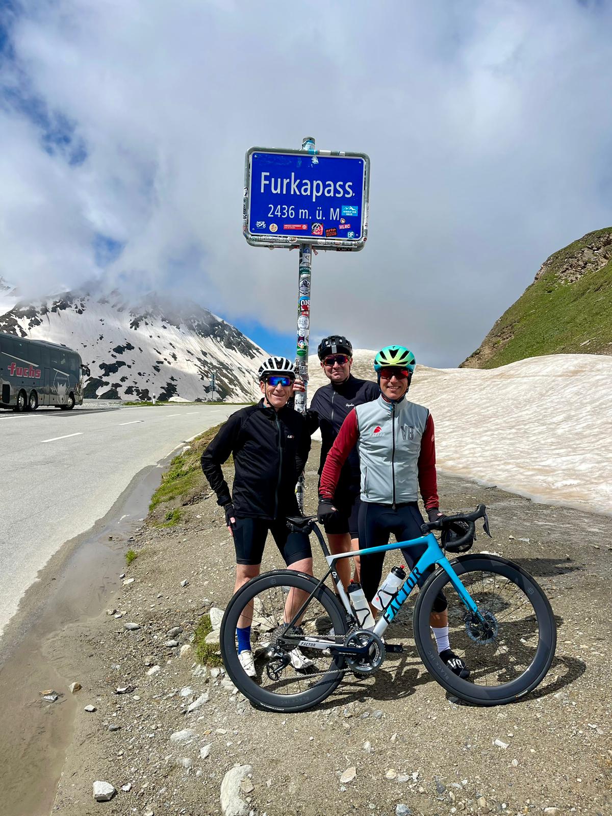 Group of cyclists at the top of the Furka pass in Switzerland