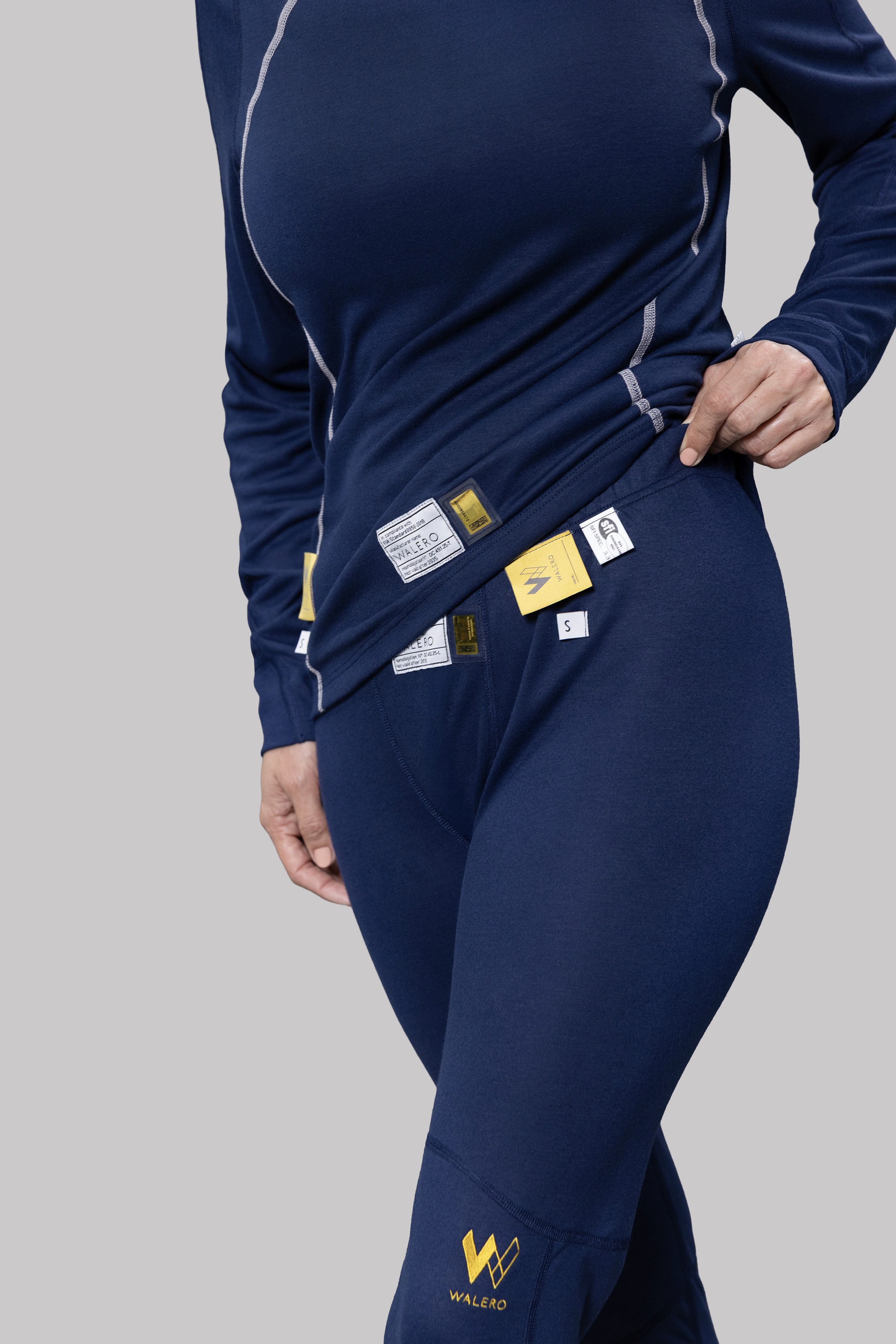 Close-up of navy Walero clothing with product labels at the waist.