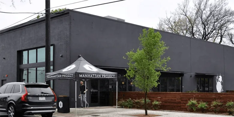 Modern dark-painted commercial building with small front patio.