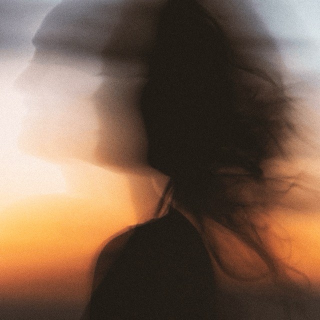 Blurred image of a woman on a sunset