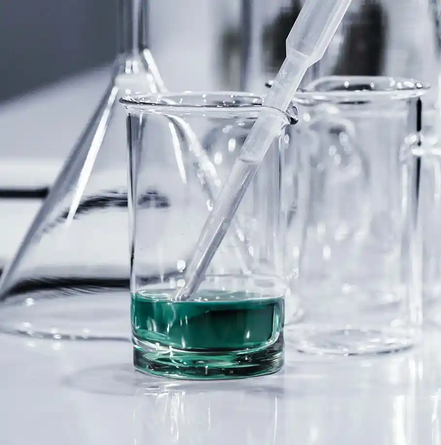 A photo of a science lab with teal green liquid in a beaker