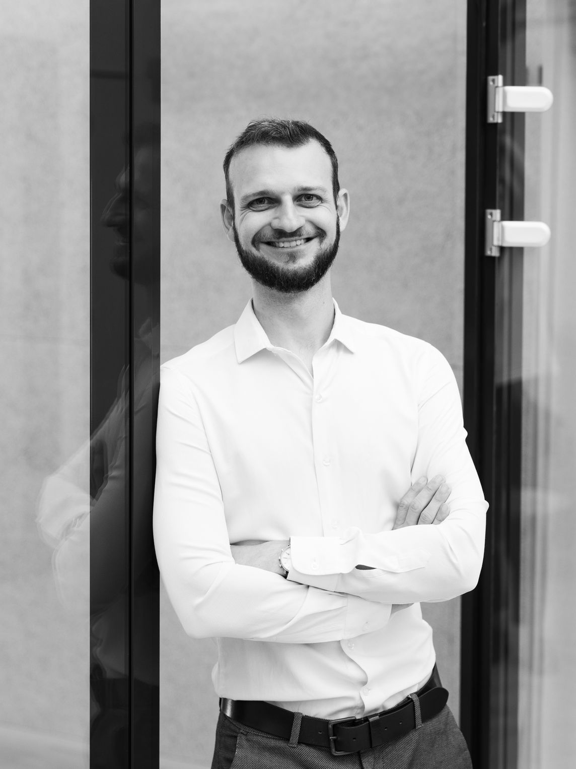 Man in fur hat hiding face with scarf at night.