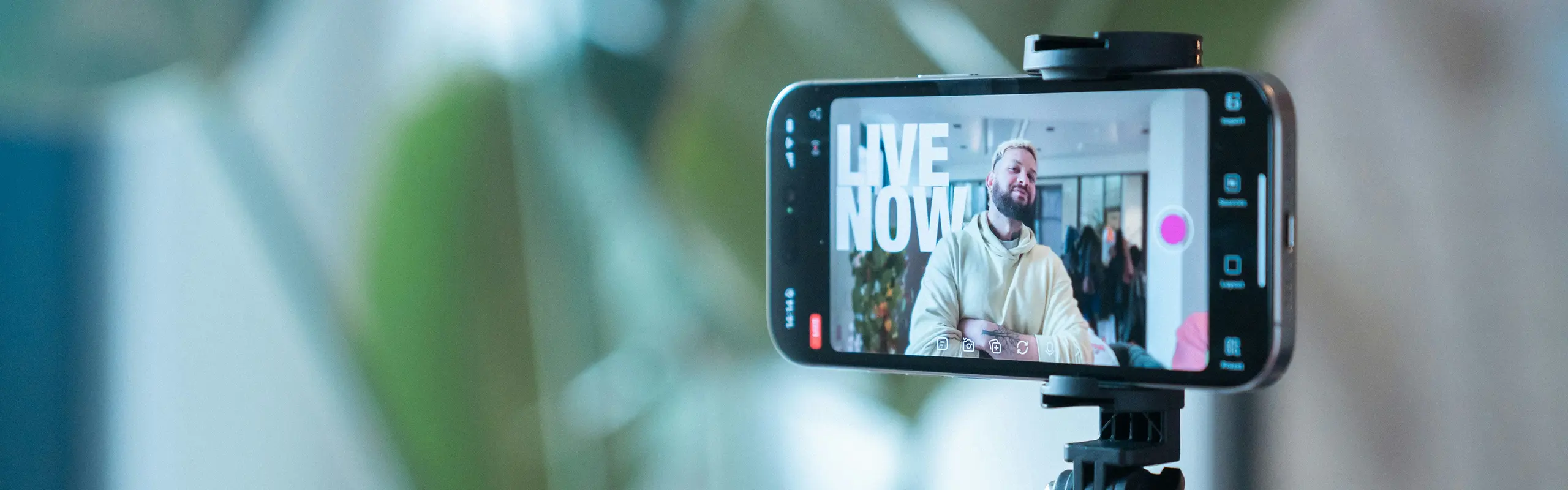 Phone on tripod showing a live stream in progress