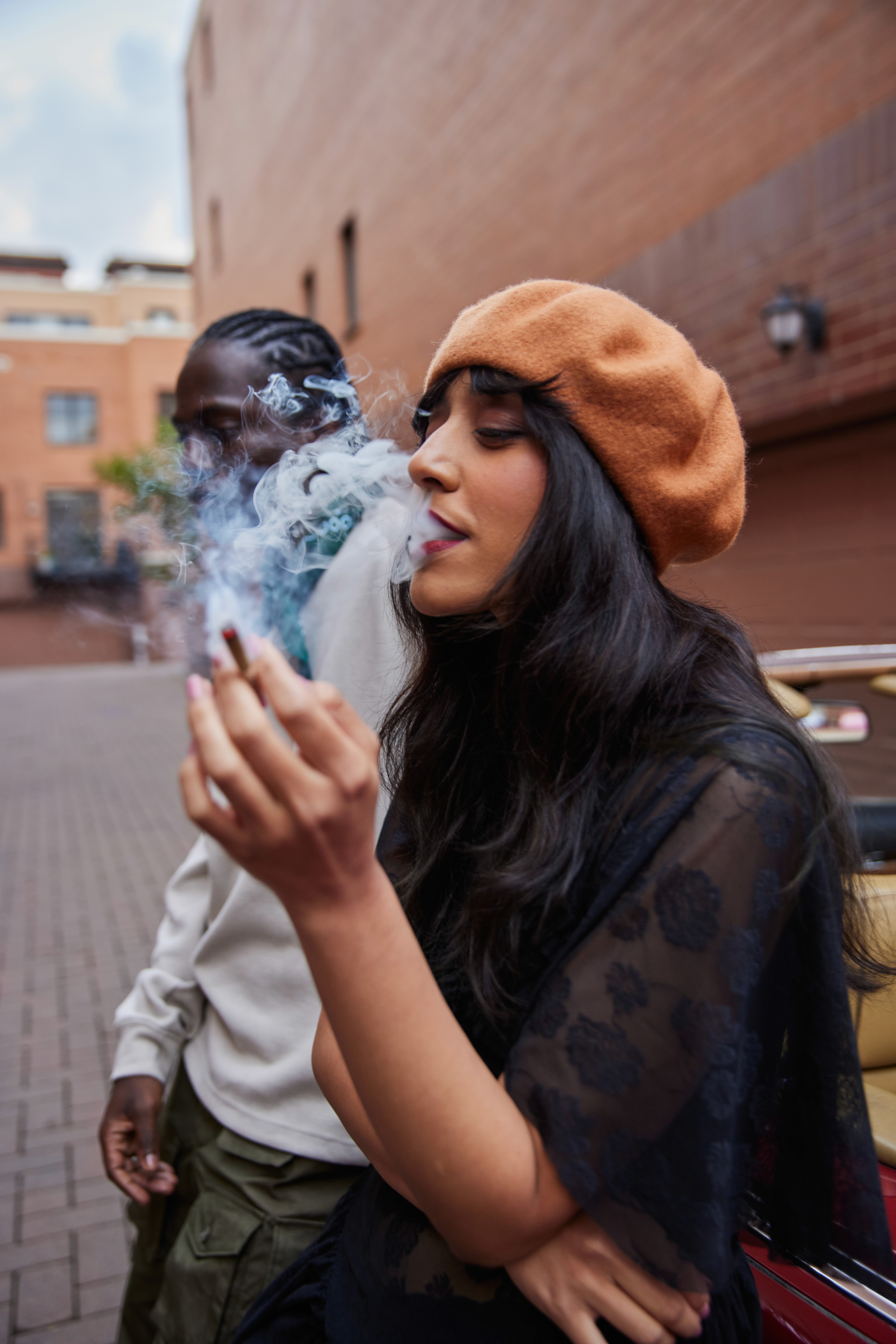 A tan sighthound stands in a grassy field.