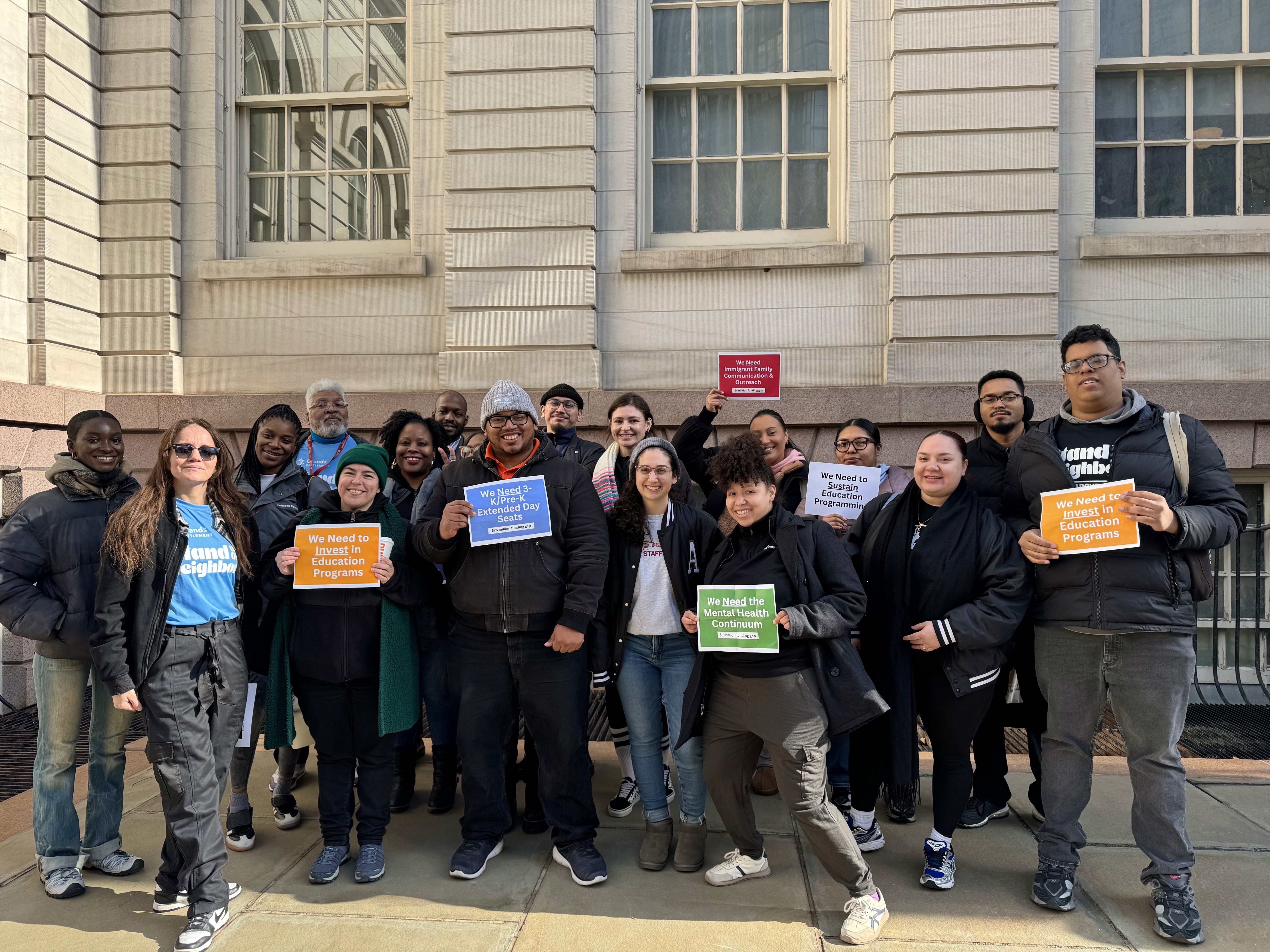 A group of people pose for a photo while advocating for increased education funding.