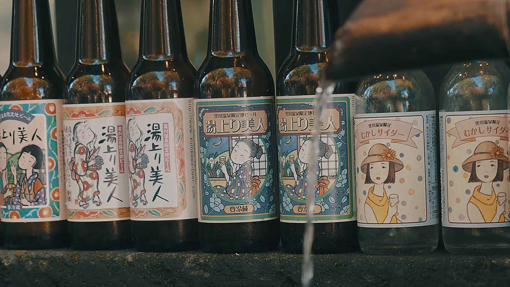 Locally bottled drinks at Kurokawa Onsen, including Yuagari Bijin and an old-style cider