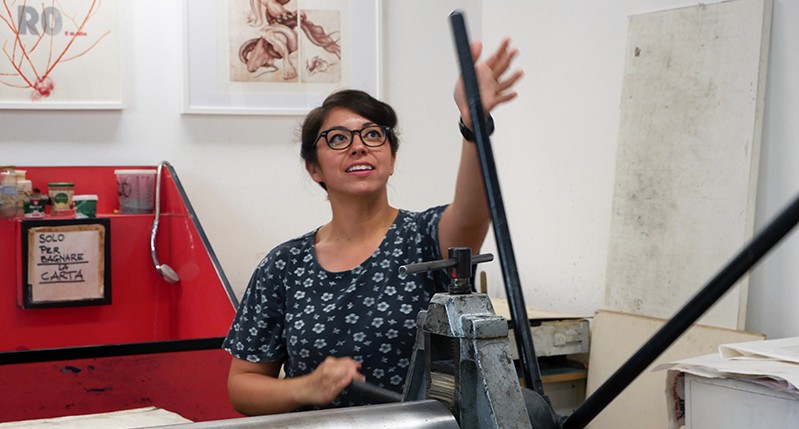 Student working at a lever for the pressing bench.