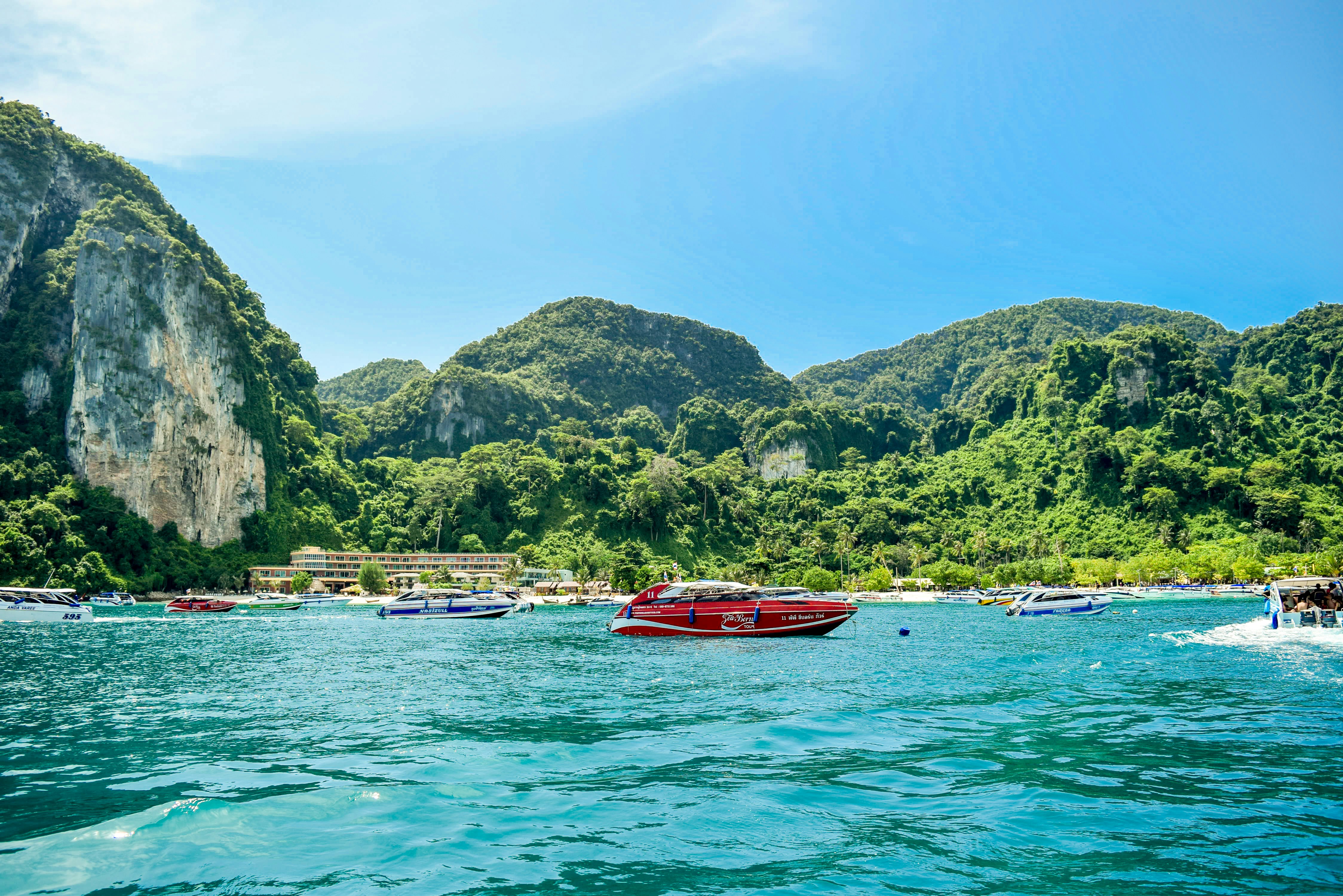 a group of boats floating on top of a body of water