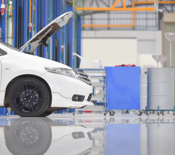 Car dealership service bay with oil-water separator floor drain and chemical runoff controls