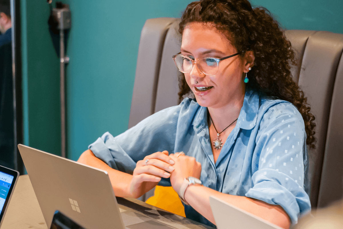 A person using a laptop in an office.