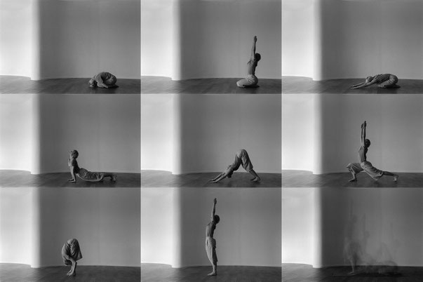a group of people doing yoga in a room