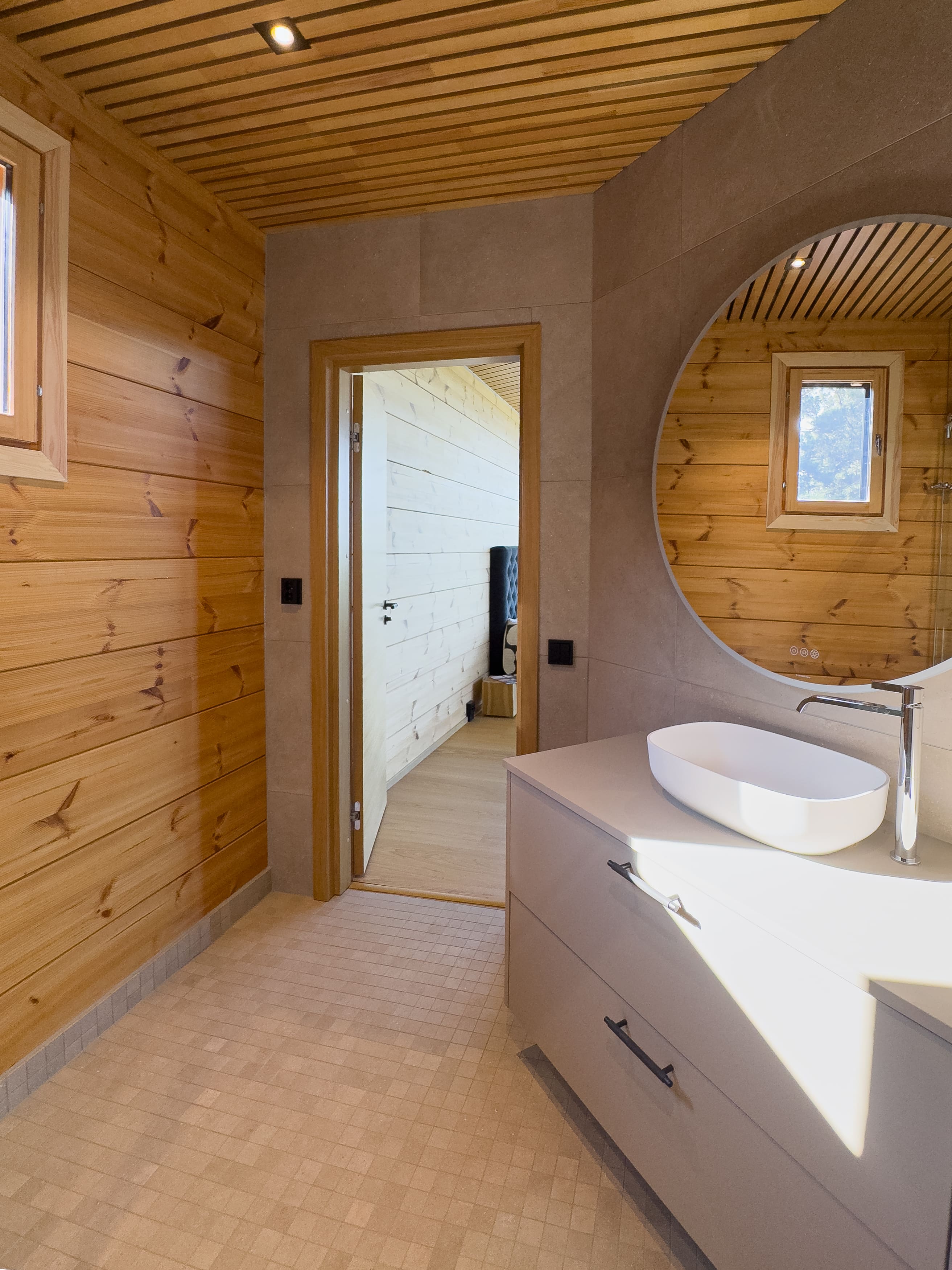 Bathroom with wooden walls and white sink