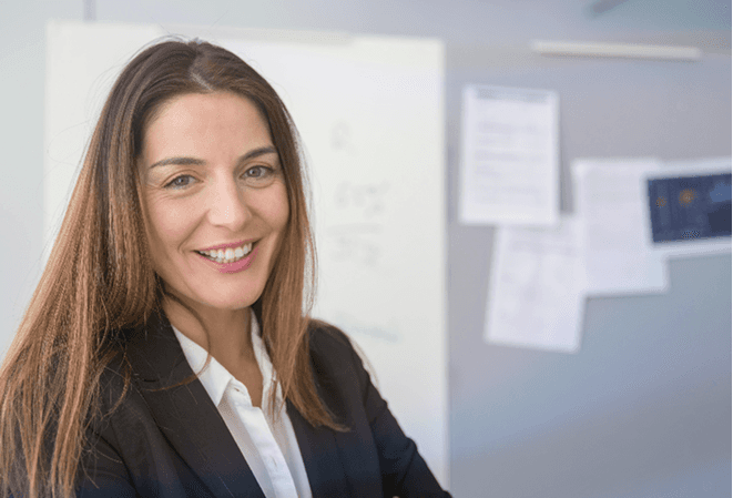 woman in red blazer holding white paper