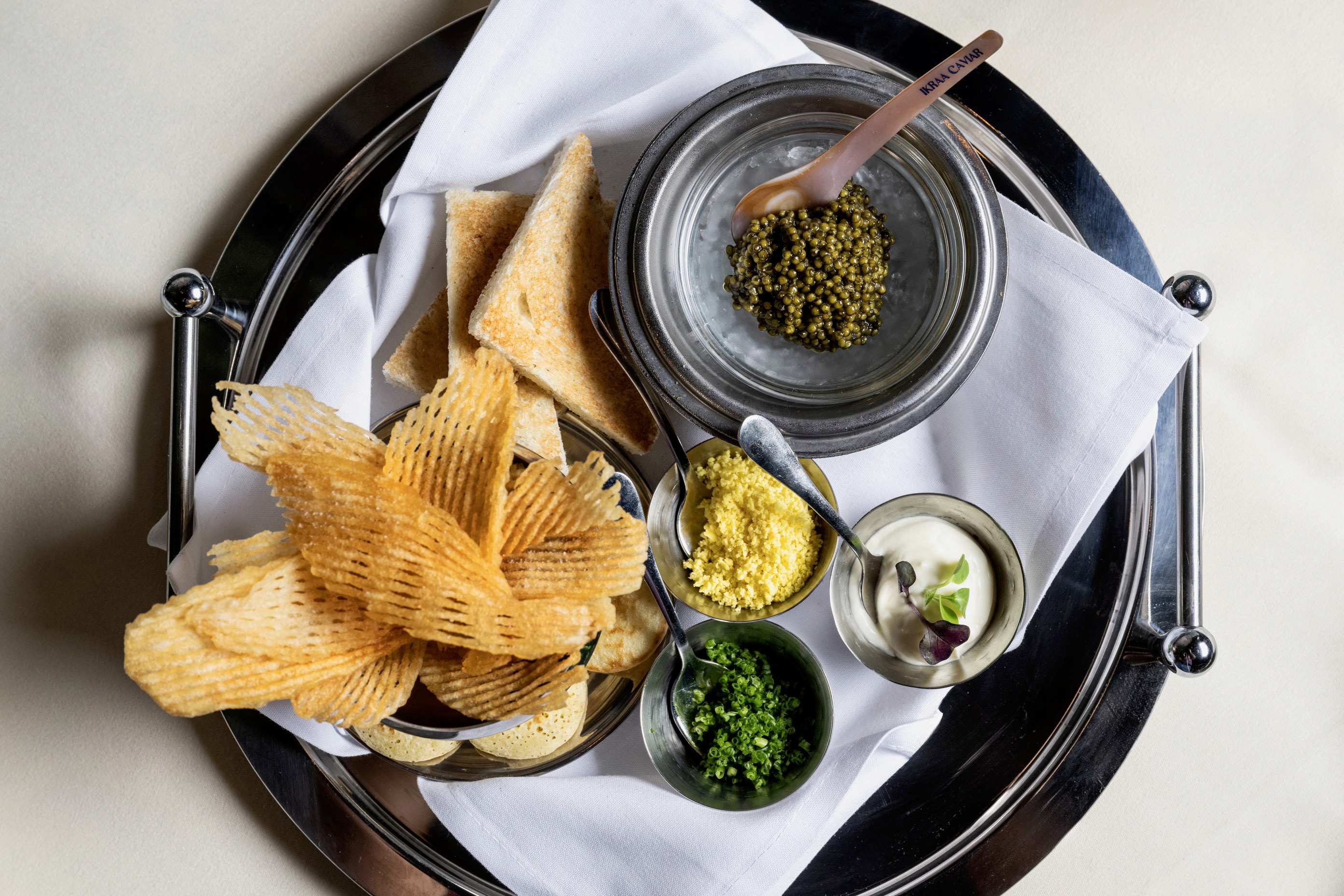 A bread, dip, and caviar platter