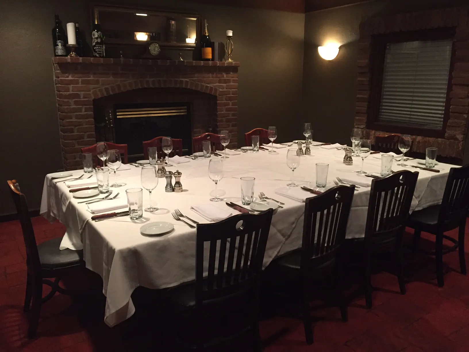 Large table set for a group by a brick fireplace at Hyde Park Prime Steakhouse Dublin