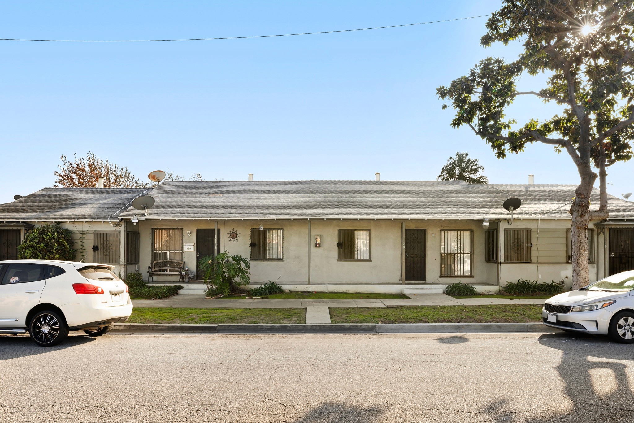 Street view of 1105 E Hyde Park exterior with mature trees and residential setting.