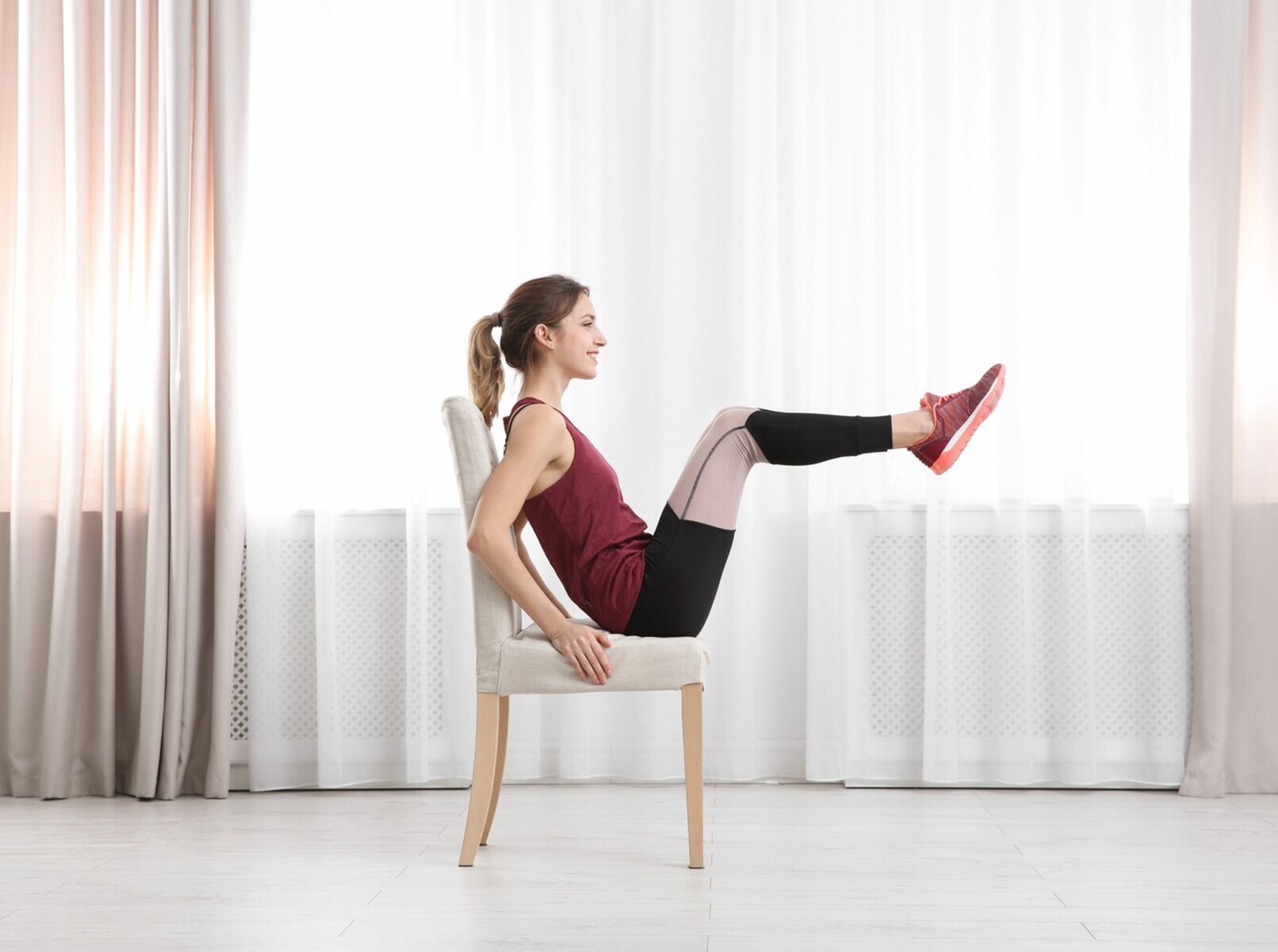 young woman doing easy chair exercises for weight loss at home