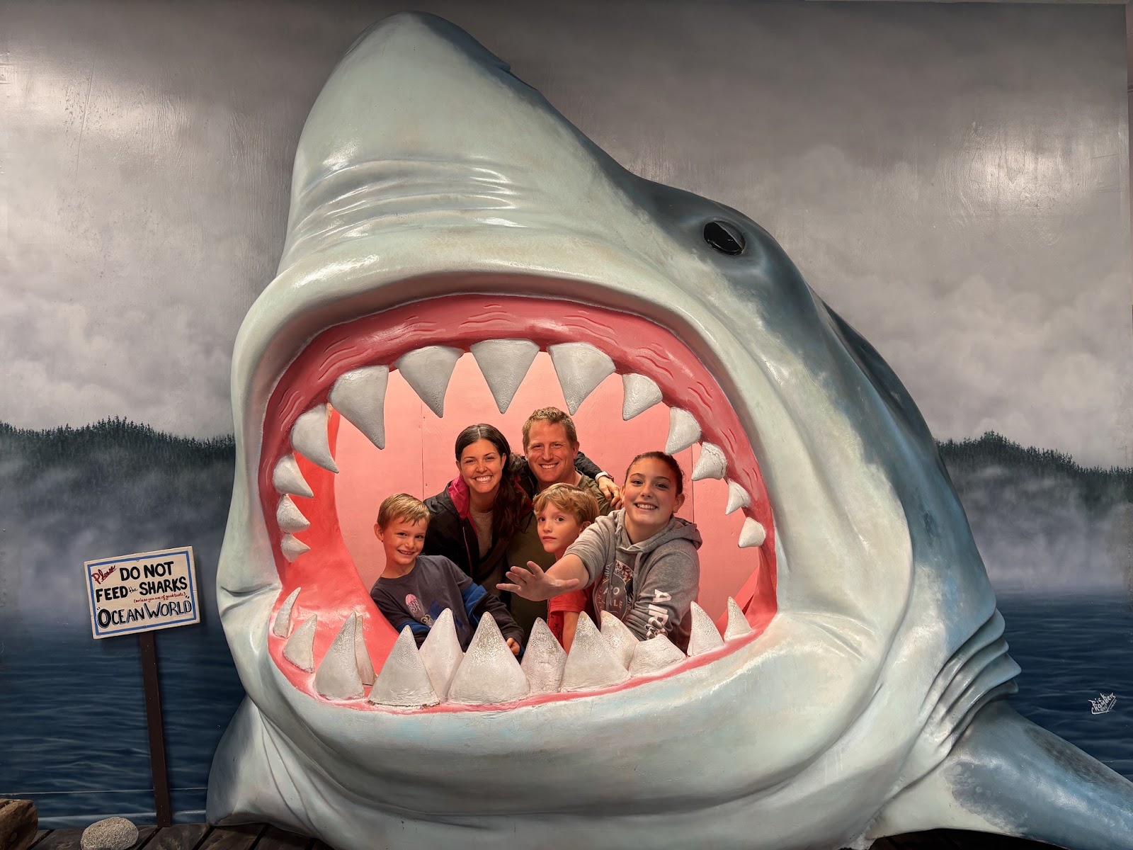 The Clark family in the shark cutout at Ocean World in Crescent City