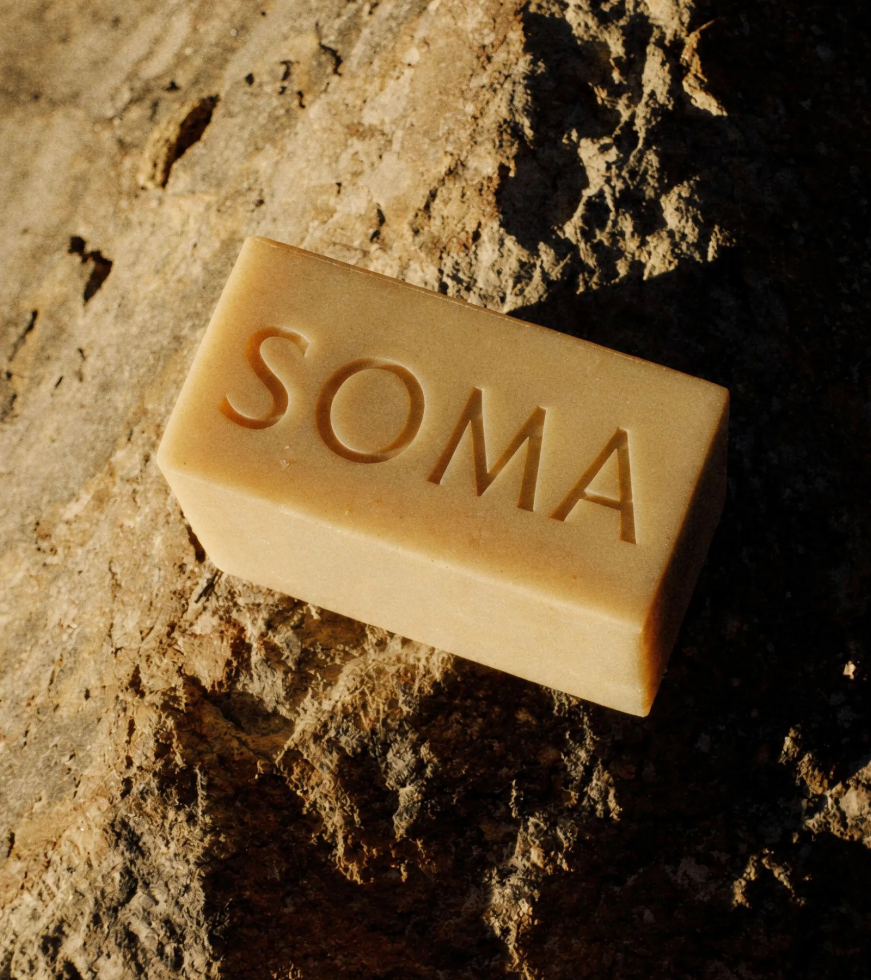 SOMA soap bar on sunlit stone