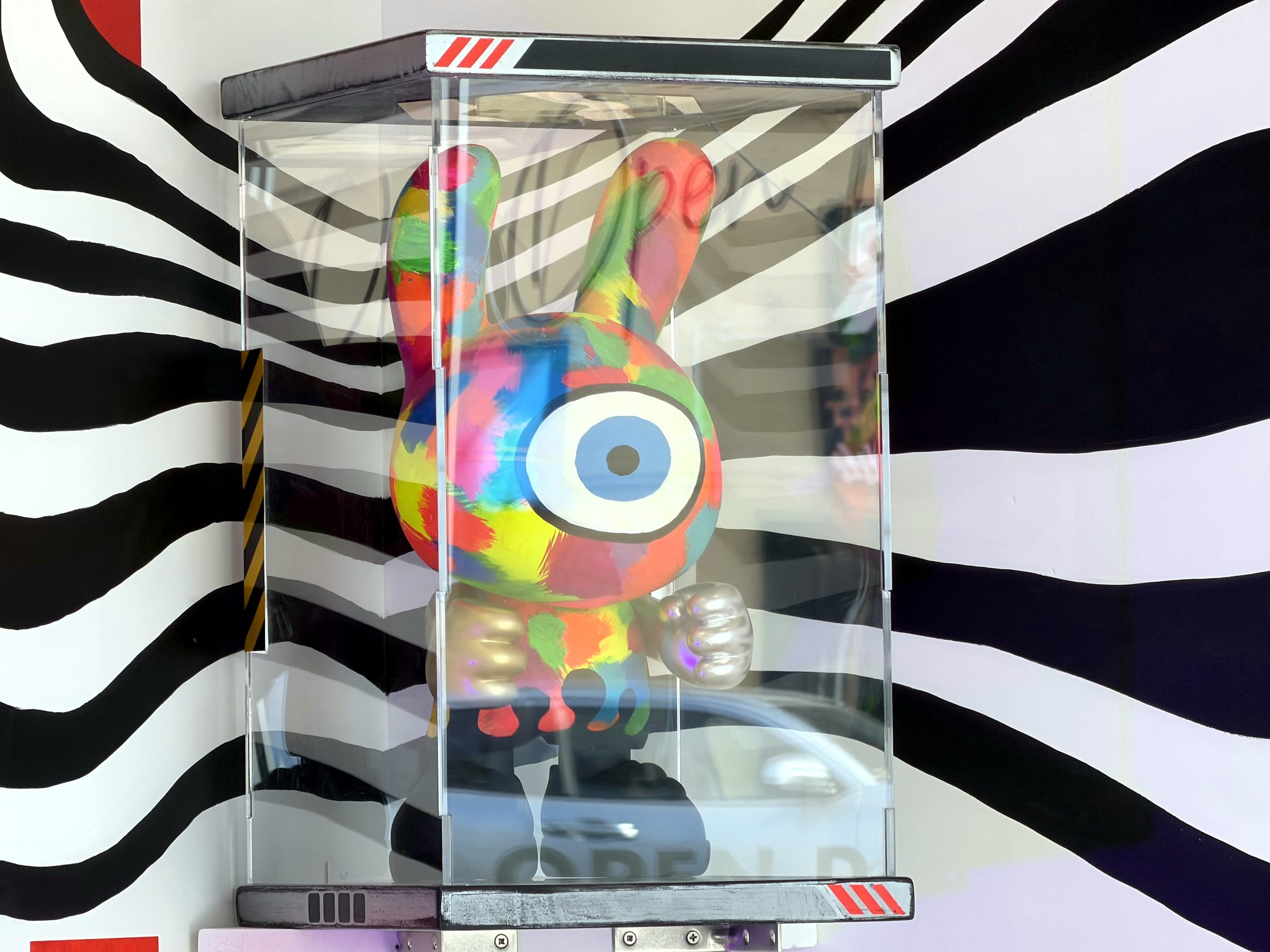 Custom painted cyclops character sculpture displayed inside a clear case at Chris N' Eddy's Glendale