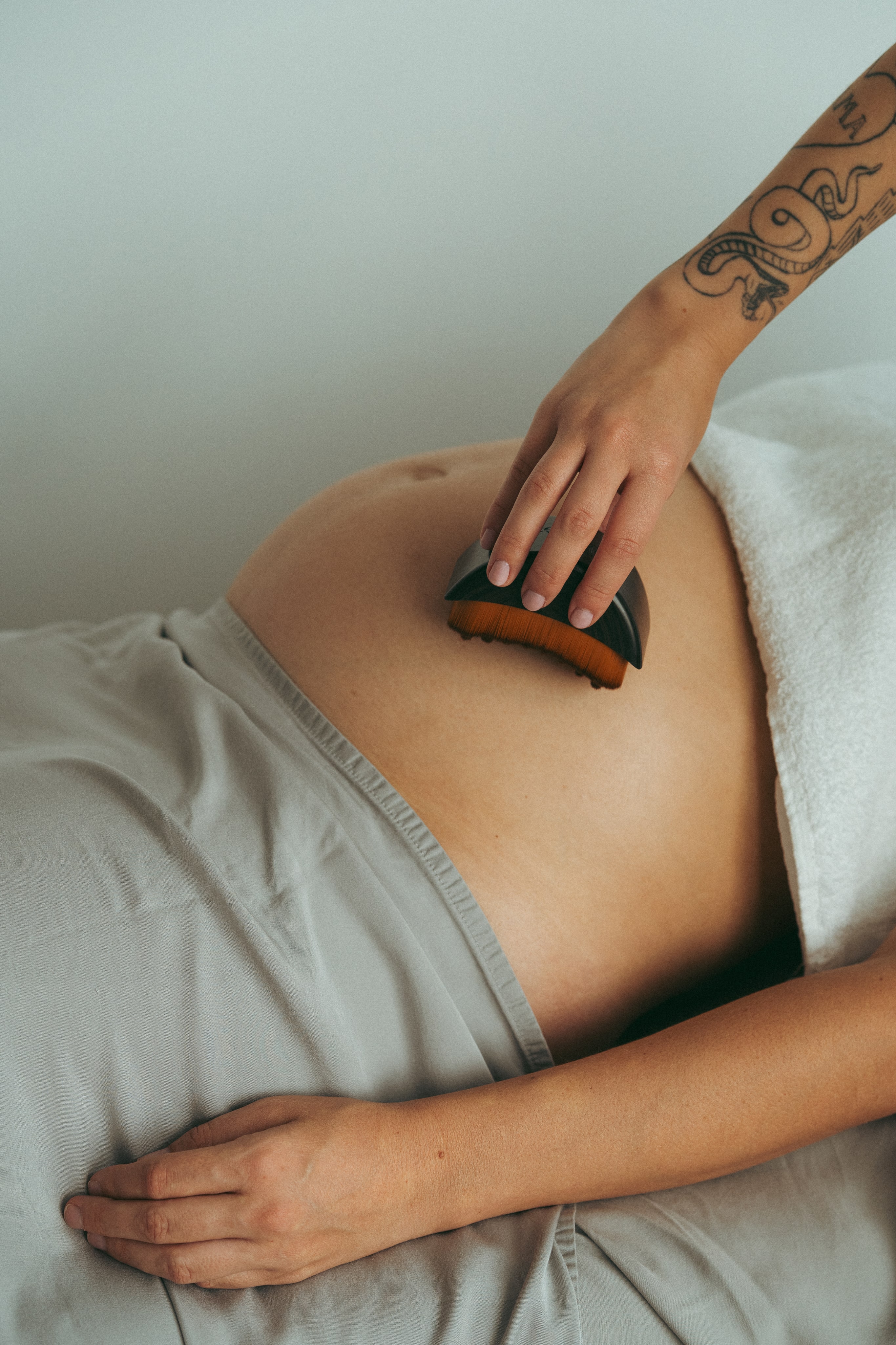 A pregnant woman enjoying a spa treatment.