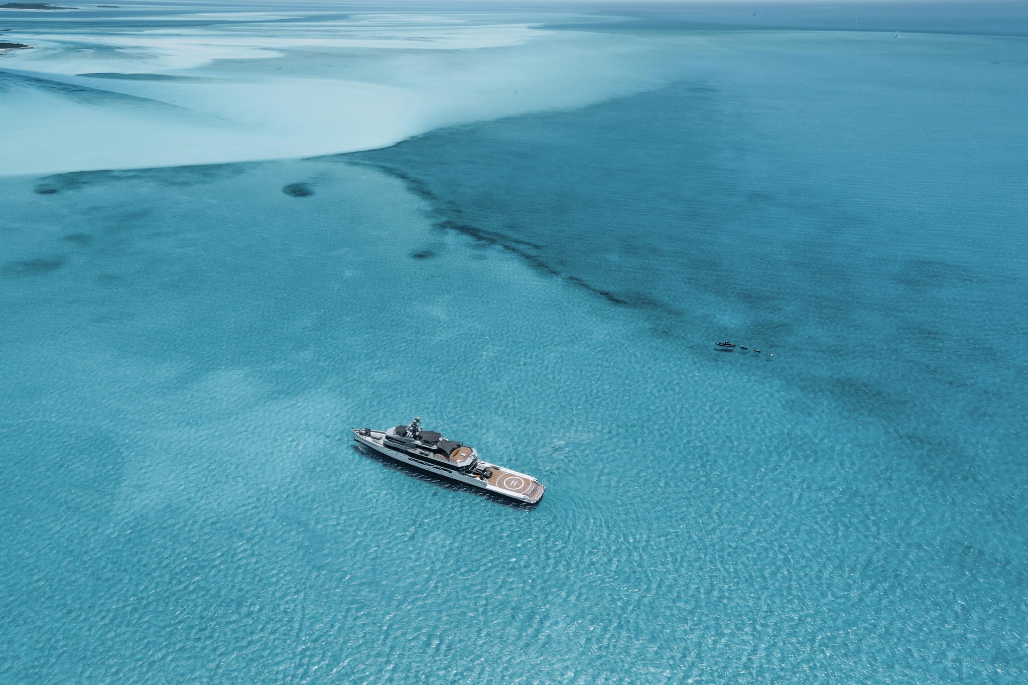 Modern orange lounge chair beside white coffee table.