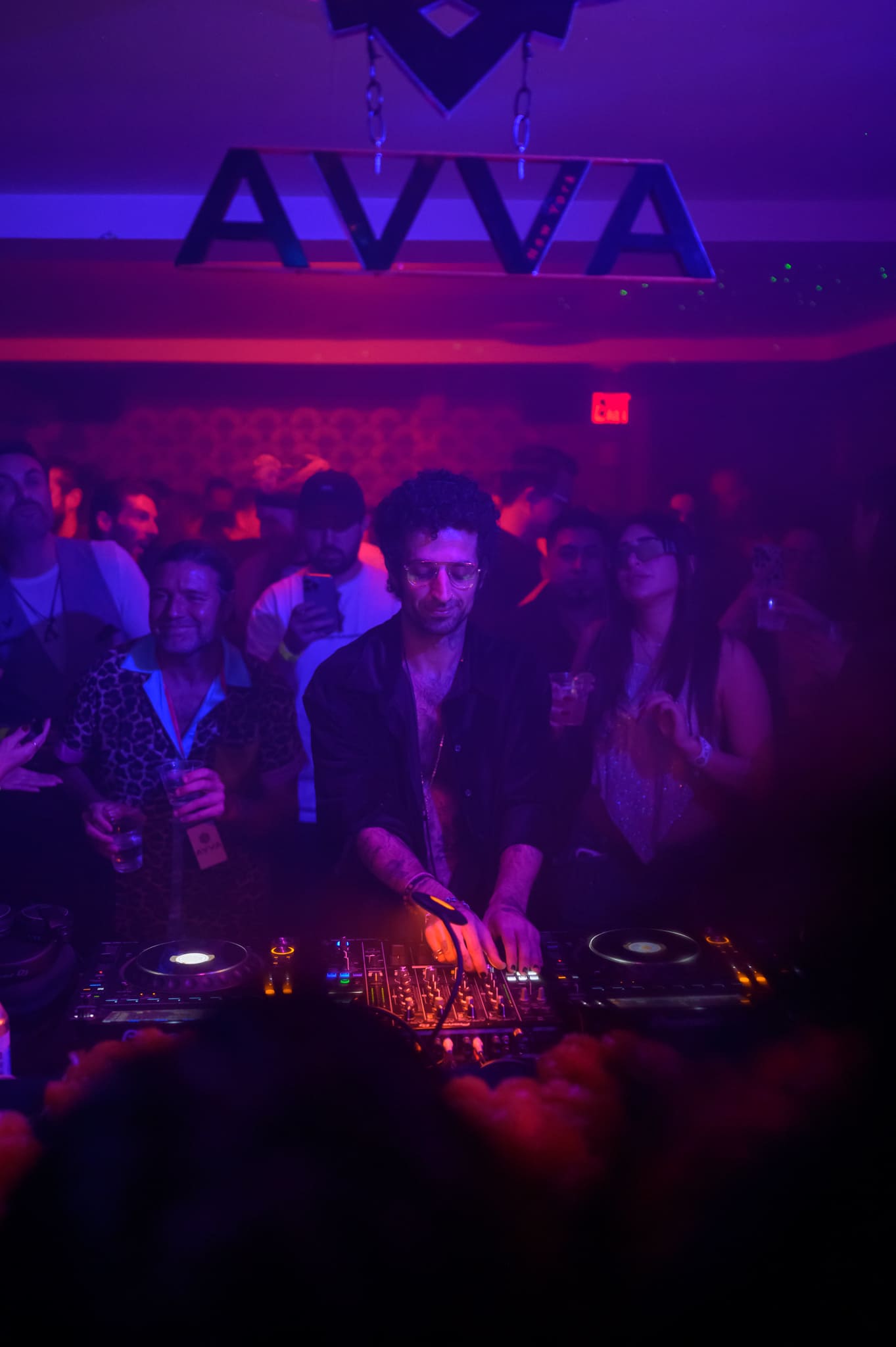 Full moon rising over a dark, silhouetted mountain ridge.
