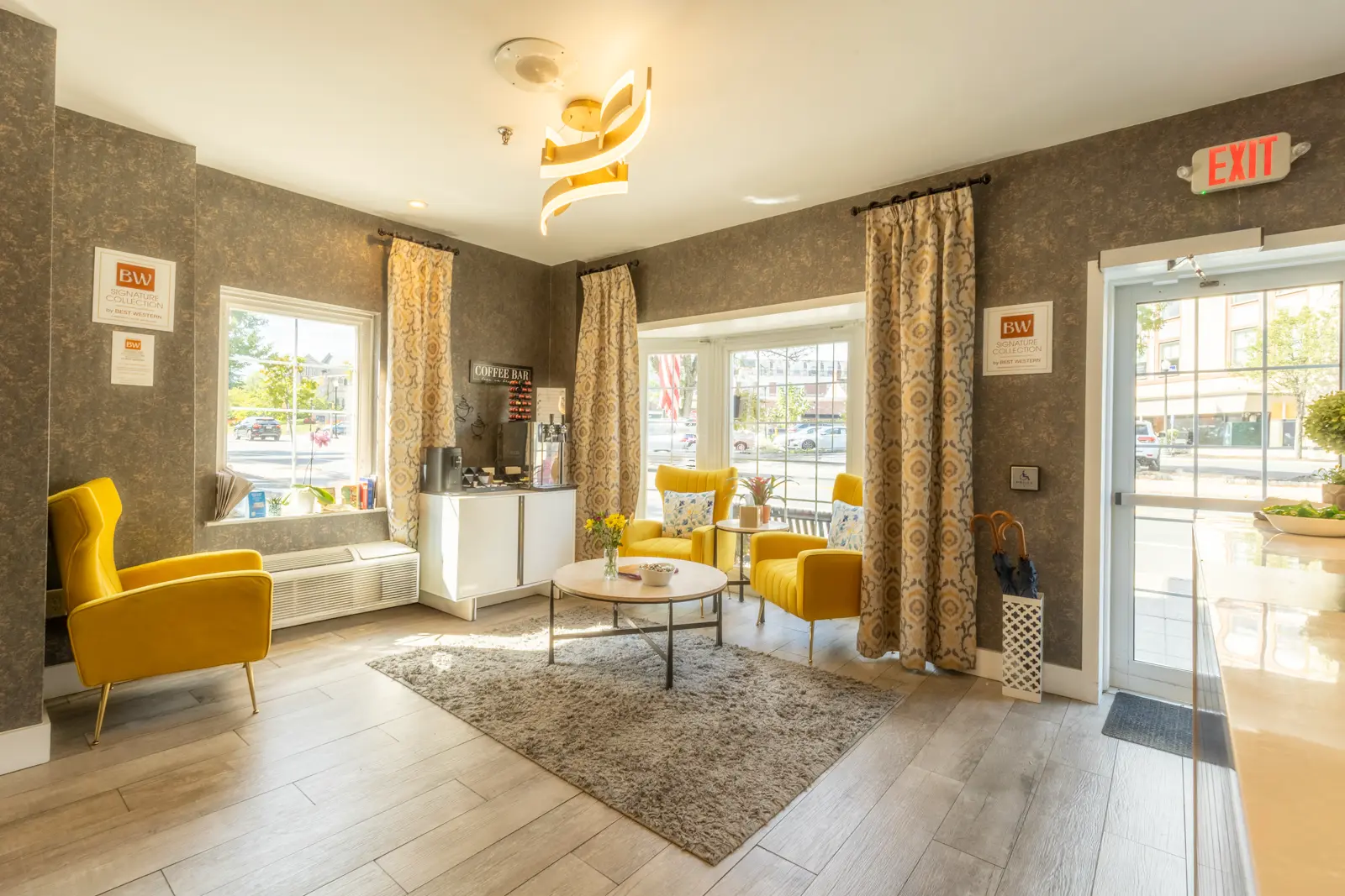 Lobby seating area with yellow chairs and coffee bar.