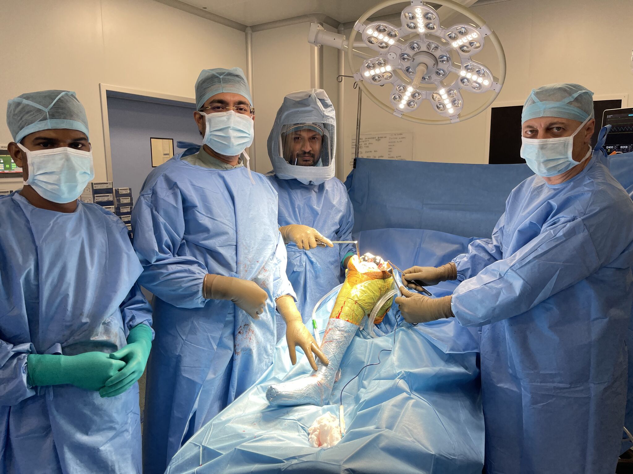 Soccer players in a stadium with blue glowing cybernetic enhancements kicking a ball