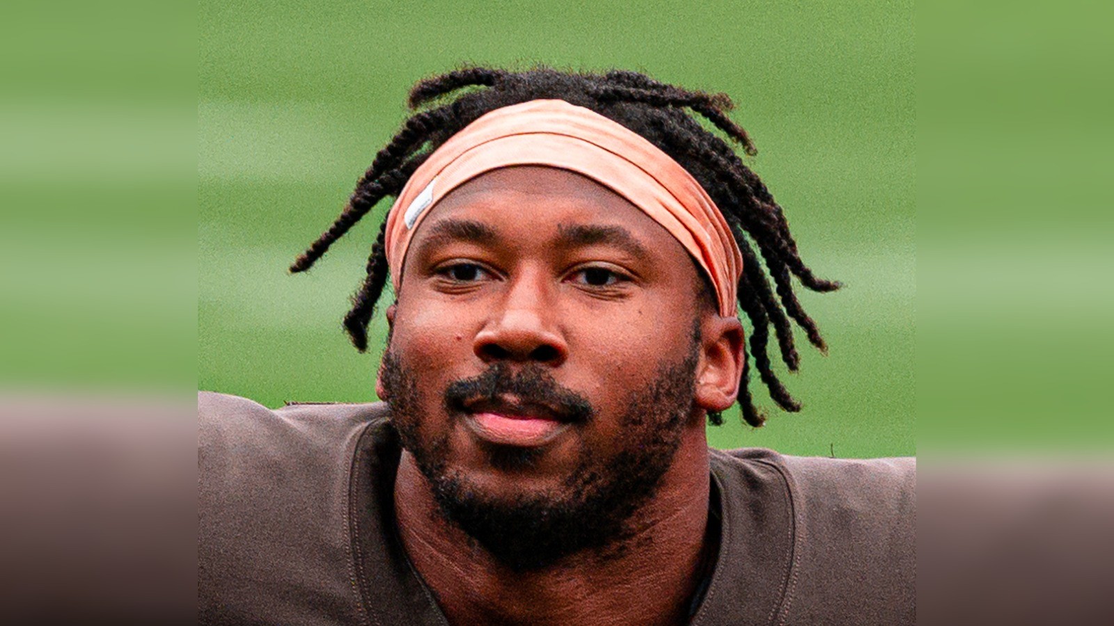 Close-up of Myles Garrett in a Browns jersey and orange headband, face centered